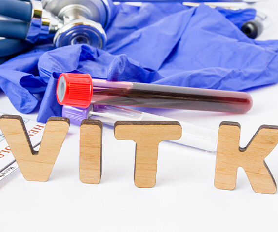 Blood sample with "VIT K" wood letters.